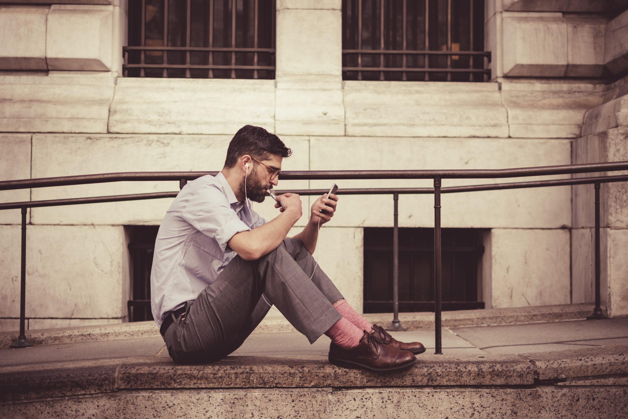 man sitting, with phone