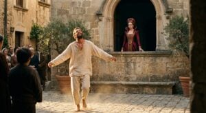 A man in peasant clothes dances in a courtyard while a woman in a regal red gown watches from an arched window
